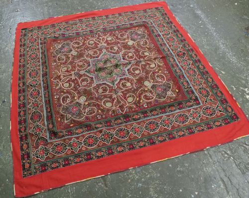 fig 2. Square antique Persian Rasht embroidery featuring a central green and pink star medallion surrounded by floral motifs on red wool felt with decorative patterned borders.