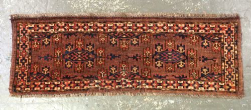 fig 1. A horizontal rectangular antique wool torba bag face featuring central diamond-shaped Kepse gul motifs in deep red, indigo blue, and ivory framed by a geometric border.