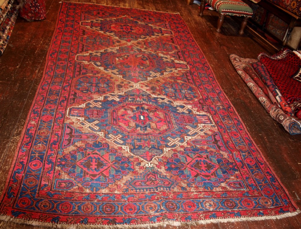 OLD CAUCASIAN SOUMAK RUG, TRADITIONAL DESIGN, SOME HEAVY WEAR, CIRCA 1920.