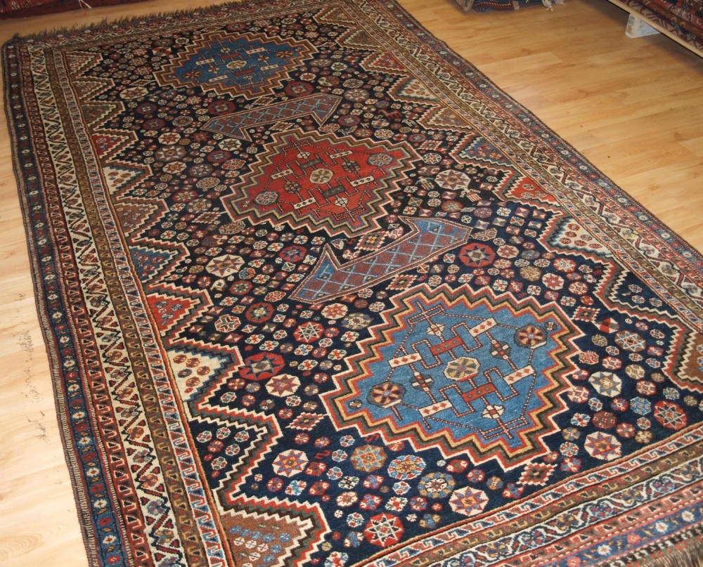 ANTIQUE LURI CARPET, THREE MEDALLIONS, FIELD OF STARS & TRIBAL DESIGN, CIRCA 1900