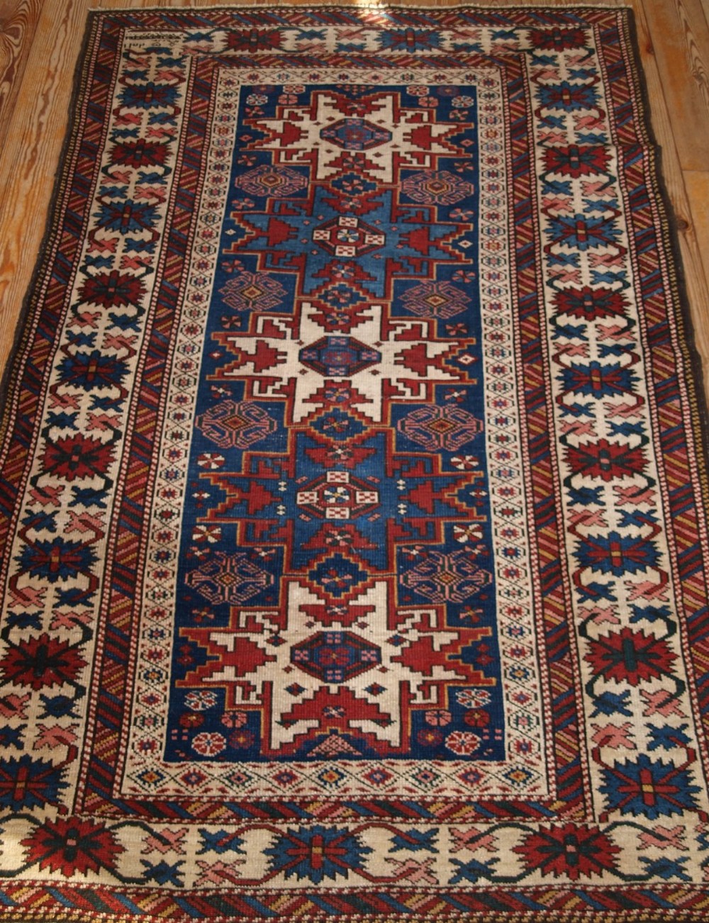 ANTIQUE CAUCASIAN RUG WITH ‘LESGHI’ STAR DESIGN, DATED 1325, CIRCA 1900