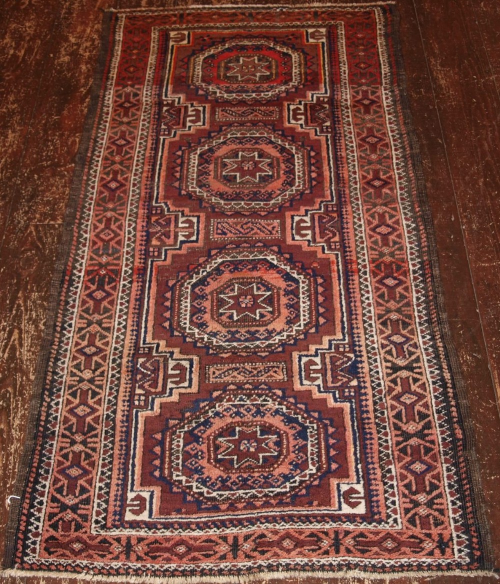 ANTIQUE BALUCH RUG WITH STAR & GUL DESIGN, AFGHANISTAN CIRCA 1900.