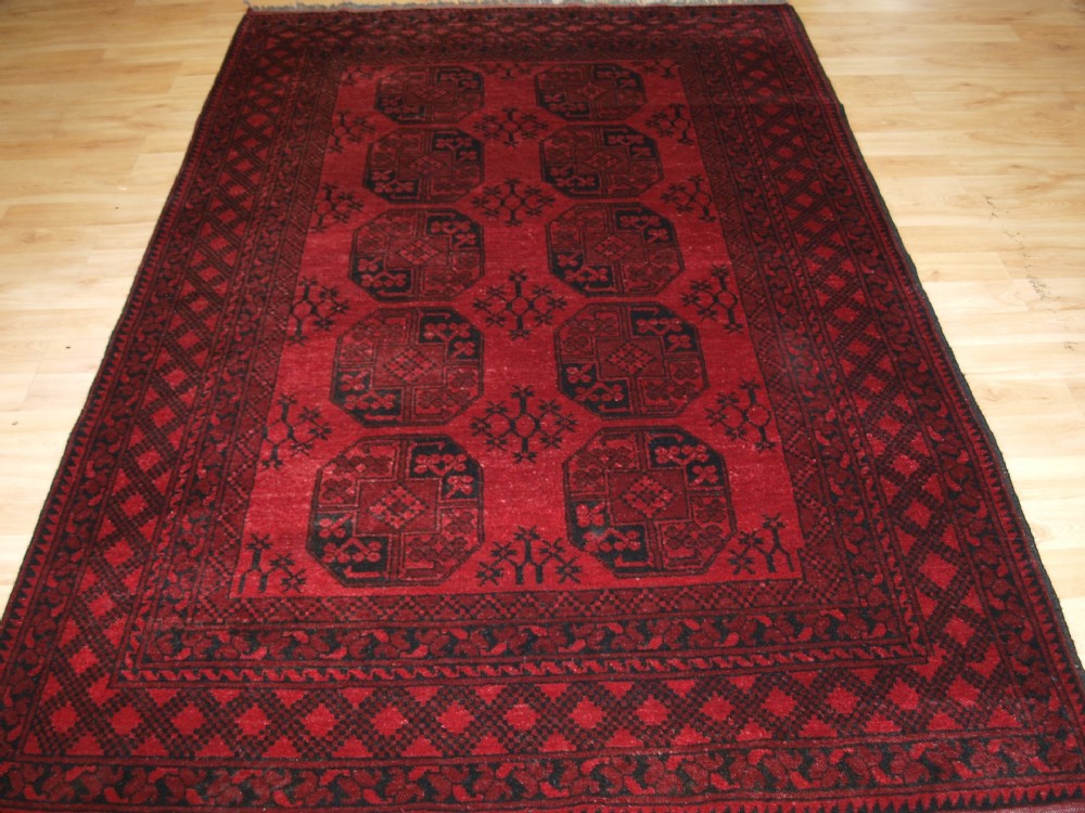 OLD AFGHAN VILLAGE RUG OF TRADITIONAL DESIGN, ABOUT 60 YEARS OLD