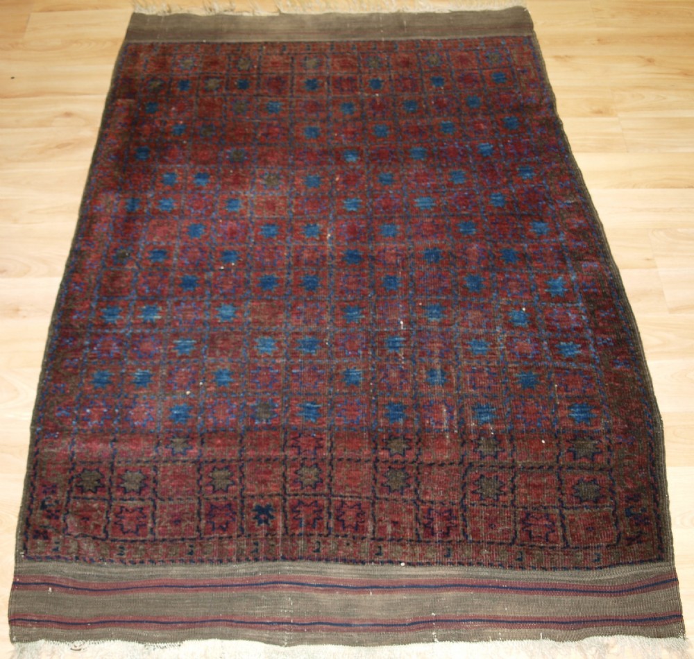 ANTIQUE AFGHAN TIMURI BALUCH RUG OF VERY UNUSUAL STAR DESIGN, CIRCA 1880.