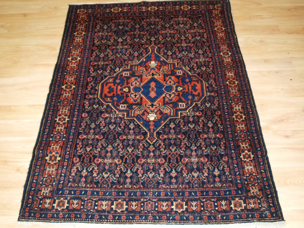 ANTIQUE SENNEH RUG, SINGLE MEDALLION WITH HERATTI DESIGN, CIRCA 1900