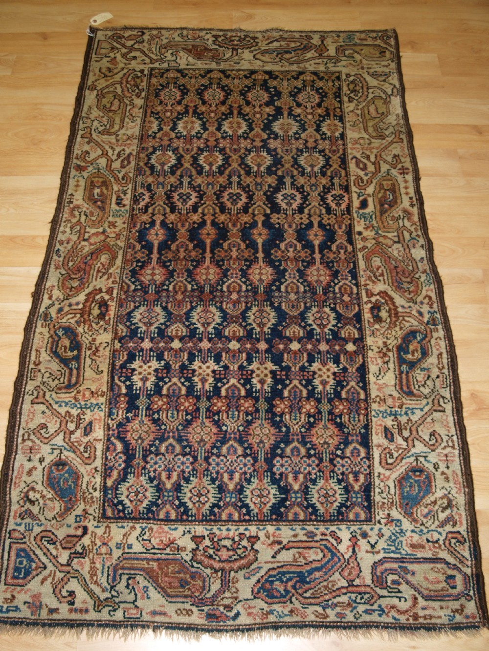 ANTIQUE KURDISH RUG WITH LARGE WILD BOTEH DESIGN BORDER, SOFT COLOURS, CIRCA 1900.