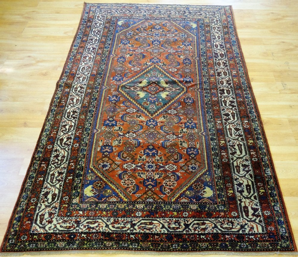 ANTIQUE NORTH WEST PERSIAN MALAYER RUG WITH MEDALLION AND HERATTI DESIGN, CIRCA 1900.
