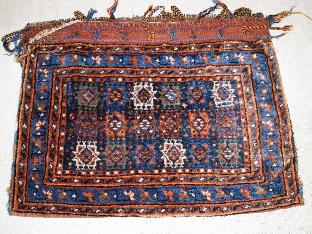 ANTIQUE SADDLE BAG WITH PLAIN WEAVE BACK, POSSIBLY AFSHAR, CIRCA 1900. (ONE OF A PAIR).
