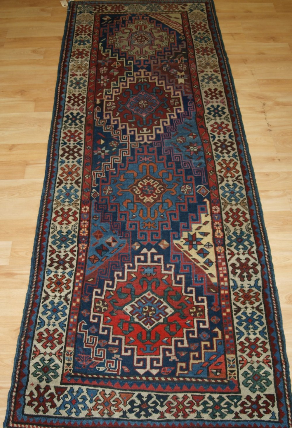 ANTIQUE CAUCASIAN KAZAK RUNNER OF SMALL SIZE, SUPERB COLOURS, CIRCA 1880.