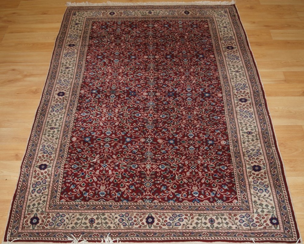 OLD TURKISH KAYSERI RUG, BURGUNDY COLOUR WITH FINE ALL OVER FLORAL DESIGN, CIRCA 1920.