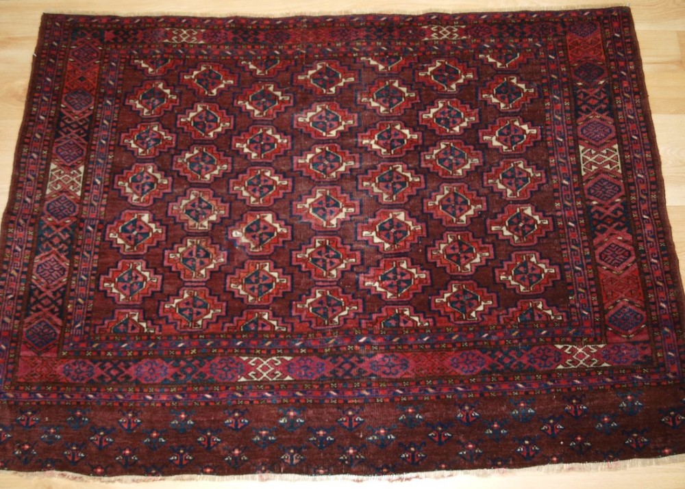 ANTIQUE ERSARI TURKMEN CHUVAL, WITH UNUSUAL OFF SET GUL DESIGN, CIRCA 1900.
