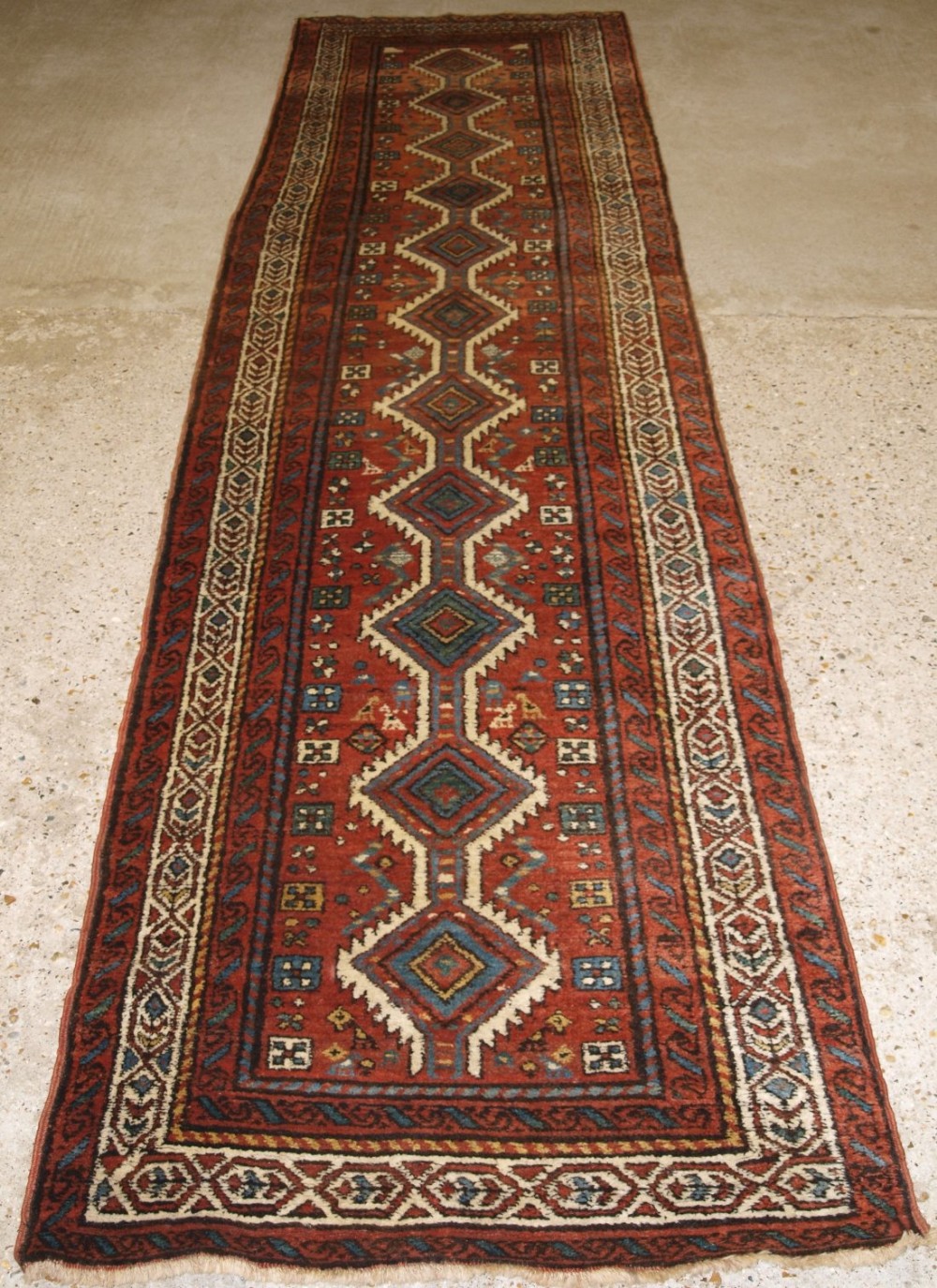 OLD NORTH WEST PERSIAN KURDISH RUNNER, HARD WEARING, TERACOTTA RED, CIRCA 1920.
