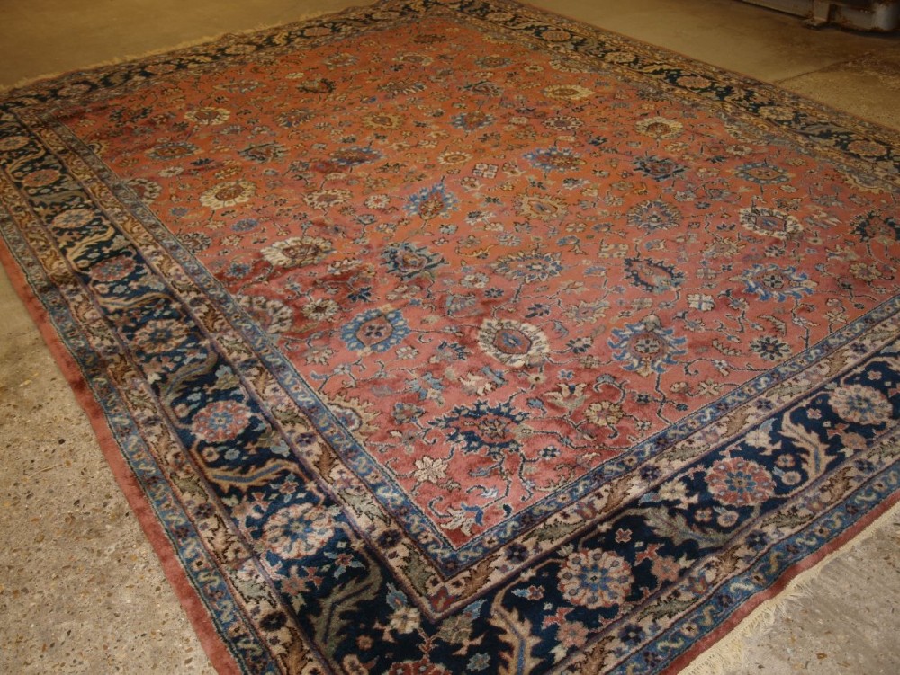 OLD TURKISH ISPARTA CARPET, CLASSIC FLORAL DESIGN, LIGHT RED GROUND WITH PASTEL COLOURS, CIRCA 1920.