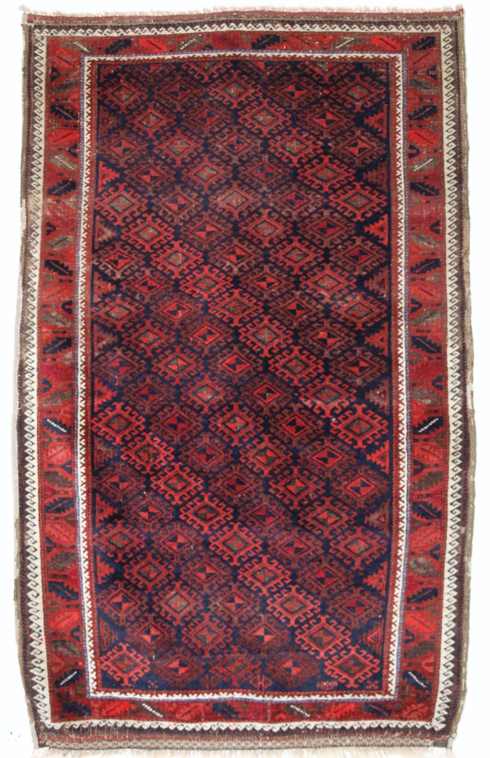ANTIQUE BALUCH RUG OF LARGER THAN NORMAL SIZE, LATCH HOOK MEDALLION LATTICE DESIGN, CIRCA 1880.