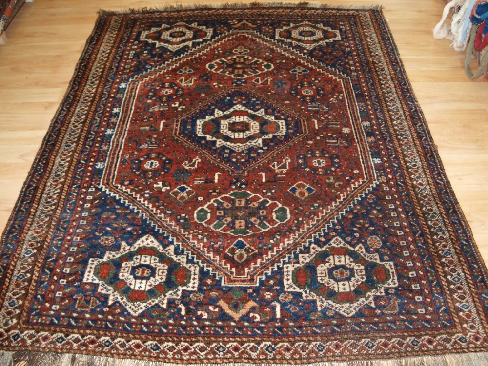 OLD SOUTH WEST PERSIAN SHIRAZ REGION RUG WITH TRIBAL DESIGN, GOOD CONDITION, CIRCA 1920.