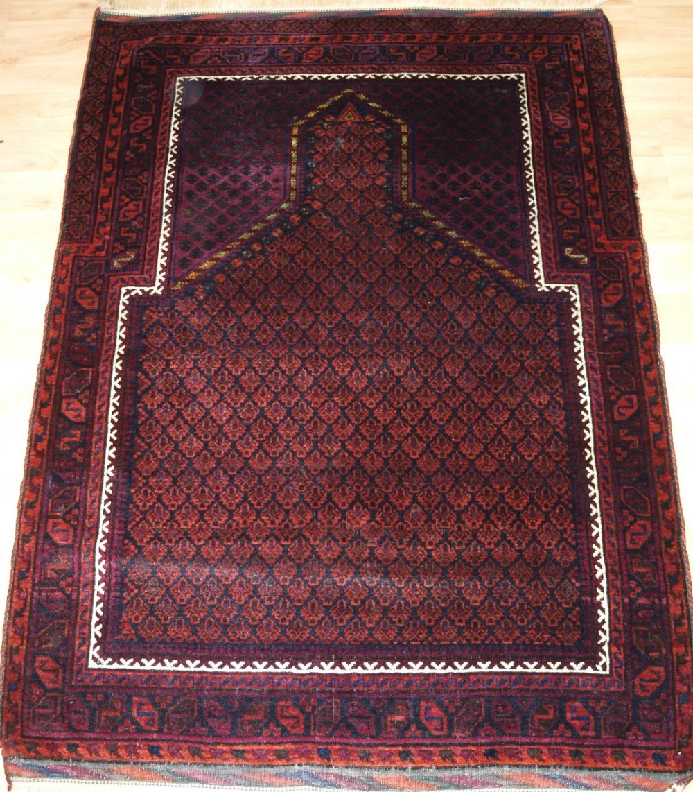 OLD BALUCH PRAYER RUG, TIMURI 'DOKHTAR-E-QAZI' DESIGN, WOOL WITH SILK HIGHLIGHTS, CIRCA 1920/30.