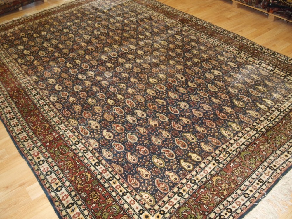 OLD TURKISH HEREKE CARPET OF ALL OVER BOTEH DESIGN, SIGNED 'HEREKE', CIRCA 1920/30.