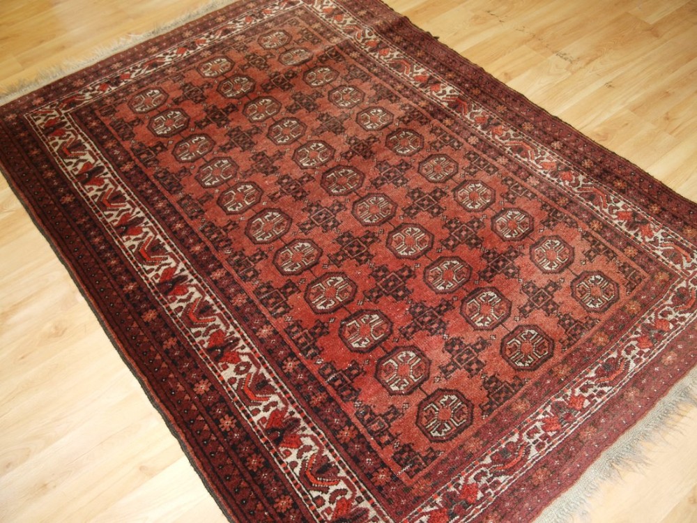 OLD AFGHAN VILLAGE RUG WITH TURKMEN DESIGN, SOFT COLOURS, CIRCA 1920.