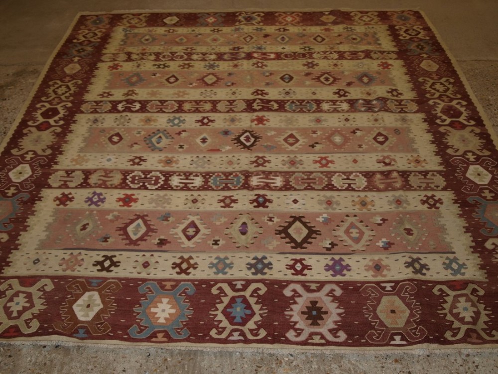 OLD TURKISH SARKOY KILIM RUG, SOFT COLOURS, BANDED DESIGN, SQUARE SHAPE, CIRCA 1920.