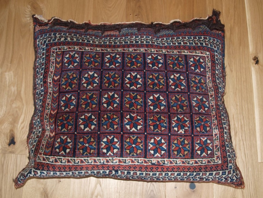 ANTIQUE SOUTH PERSIAN AFSHAR TRIBAL SADDLE BAG, FILLED AS A FLOOR CUSHION, CIRCA 1900.