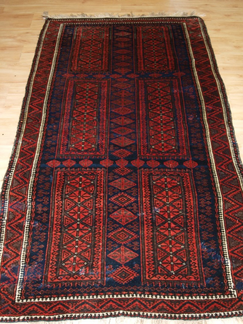 ANTIQUE AFGHAN BALUCH RUG WITH TIMURI DESIGN, CIRCA 1900.