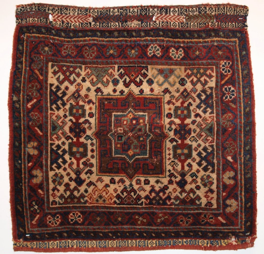 ANTIQUE SOUTH WEST PERSIAN KHAMSEH BAG OF SMALL SIZE WITH A WHITE GROUND, CIRCA 1900.