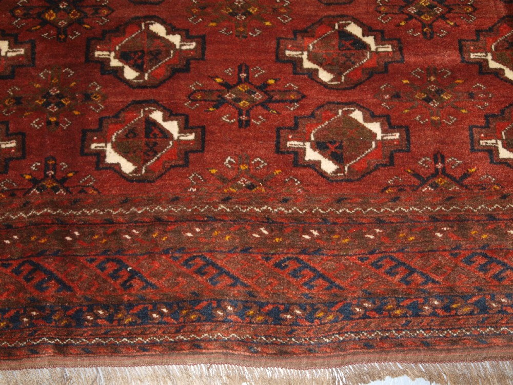 OLD AFGHAN VILLAGE CARPET, ERSARI WEAVERS, CHUVAL GUL DESIGN, CIRCA 1920. View X