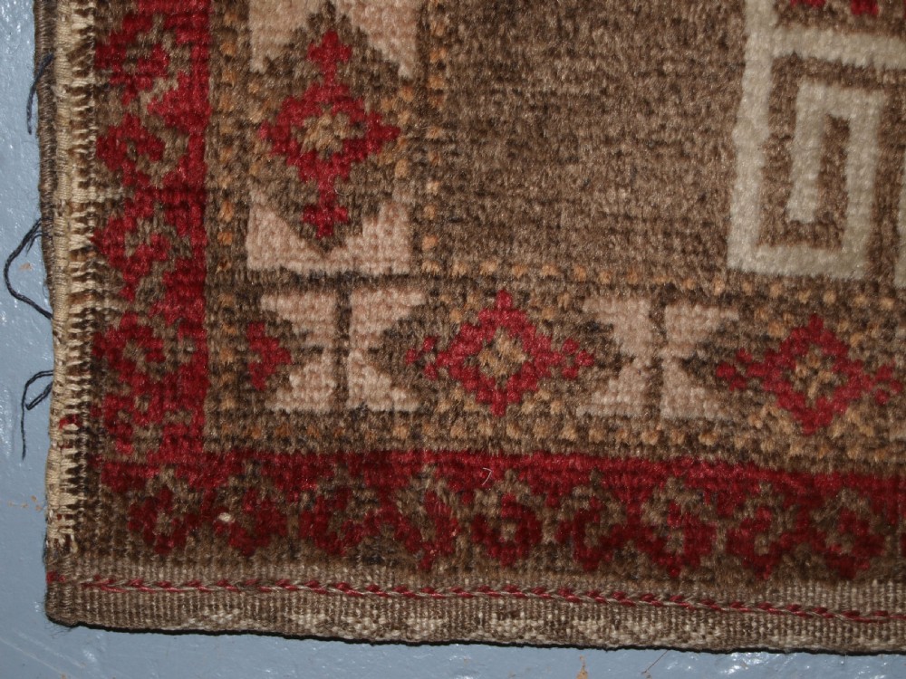 OLD AFGHAN BALUCH SADDLE BAG OF TRADITIONAL DESIGN WITH PLAIN WEAVE BACK, CIRCA 1920. View V
