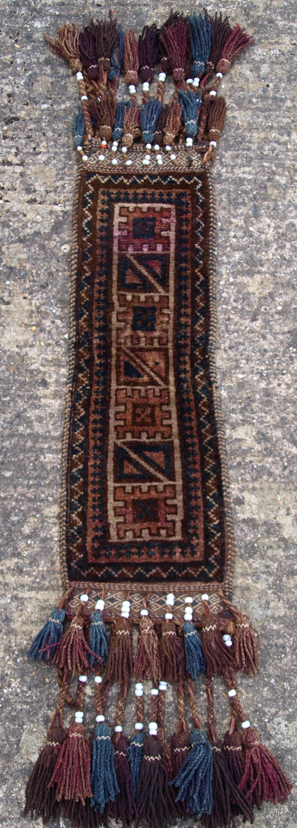 OLD AFGHAN BALUCH CAMEL TRAPPING WITH TASSELS AND BEADS, CIRCA 1920.