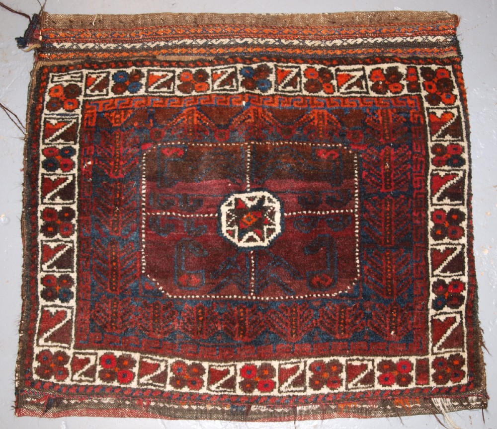 ANTIQUE AFGHAN BALUCH SADDLE BAG WITH PLAIN WEAVE BACK, CIRCA 1900.