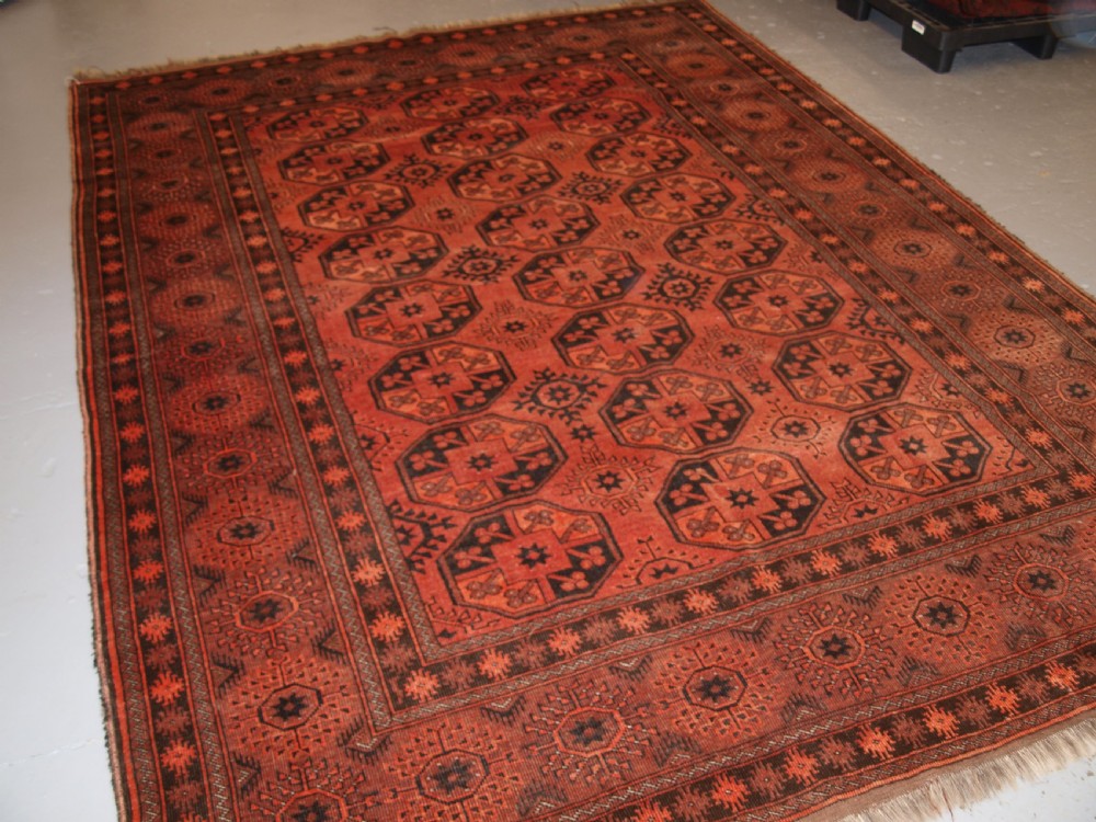 OLD AFGHAN VILLAGE CARPET OF TRADITIONAL DESIGN, SOFT BURNT ORANGE COLOUR, CIRCA 1920.