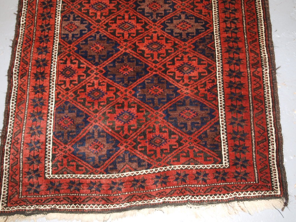 ANTIQUE BALUCH RUG WITH LATTICE DESIGN, STAR BORDER, CIRCA 1900. View IV