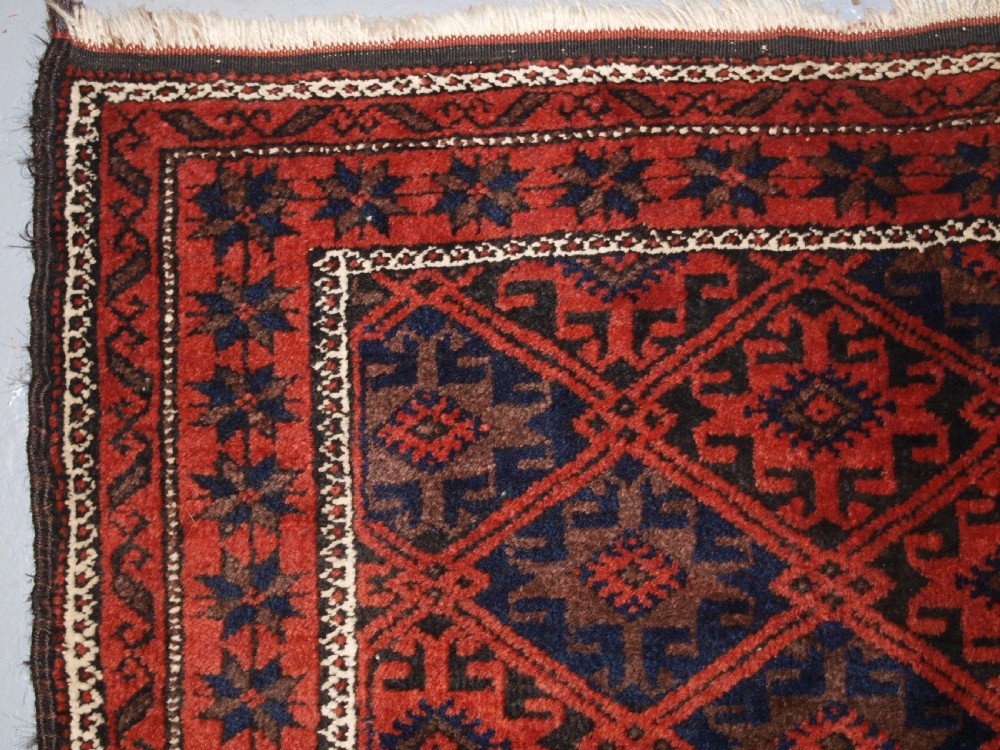 ANTIQUE BALUCH RUG WITH LATTICE DESIGN, STAR BORDER, CIRCA 1900. View V
