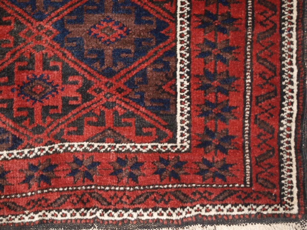ANTIQUE BALUCH RUG WITH LATTICE DESIGN, STAR BORDER, CIRCA 1900. View IX
