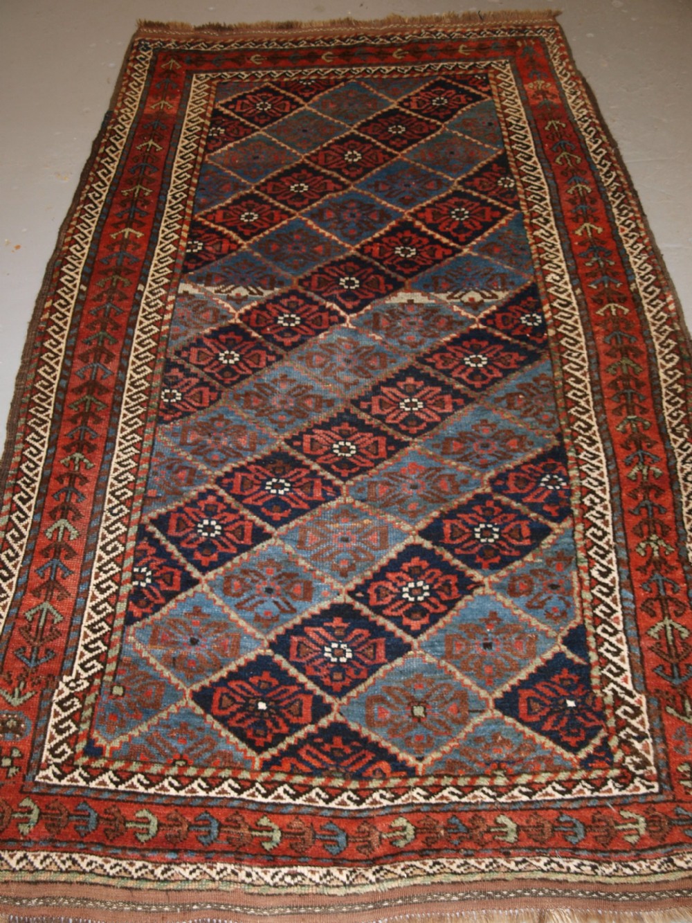 ANTIQUE KORDI RUG, KURDS OF KHORASSAN, LIGHT BLUE GROUND, CIRCA 1900.