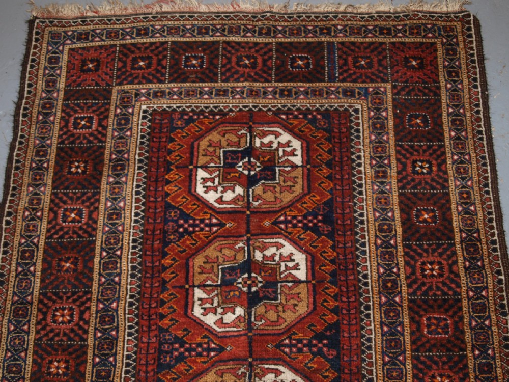 ANTIQUE BALUCH RUG BY THE MAHDAD KHANI TRIBE, LARGE TEKKE GULS, CIRCA 1900. View II