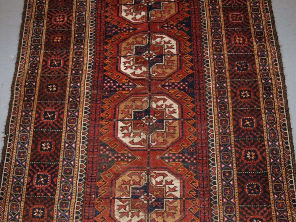 ANTIQUE BALUCH RUG BY THE MAHDAD KHANI TRIBE, LARGE TEKKE GULS, CIRCA 1900. View III