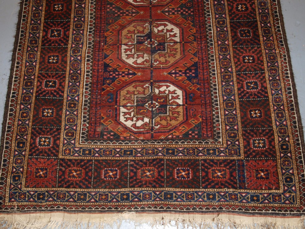 ANTIQUE BALUCH RUG BY THE MAHDAD KHANI TRIBE, LARGE TEKKE GULS, CIRCA 1900. View IV