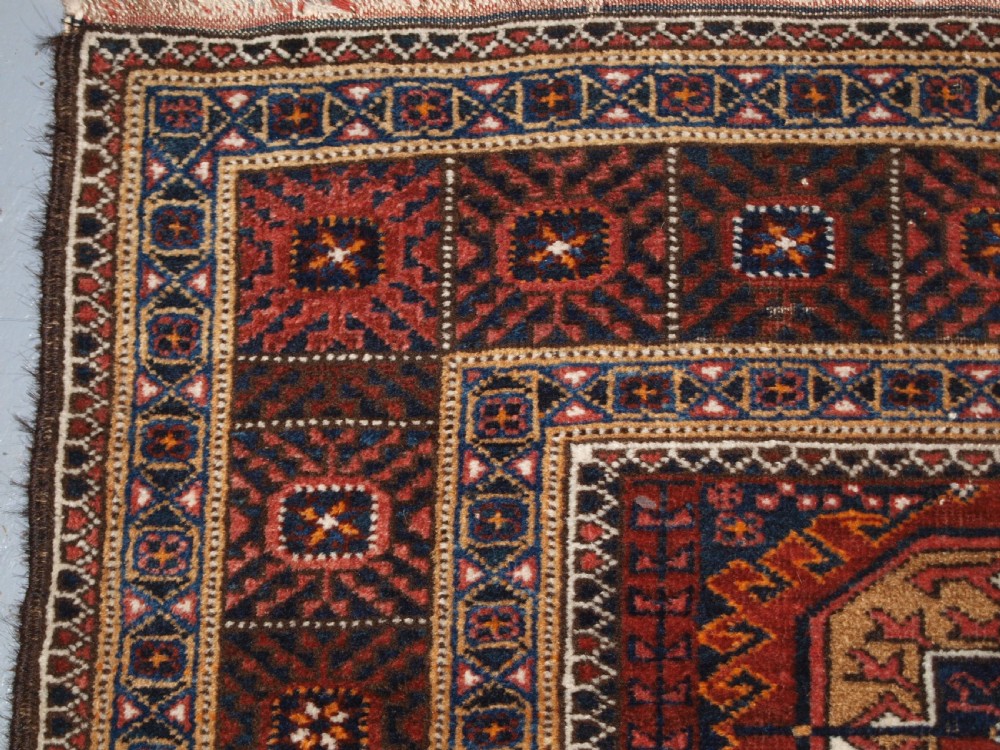 ANTIQUE BALUCH RUG BY THE MAHDAD KHANI TRIBE, LARGE TEKKE GULS, CIRCA 1900. View V