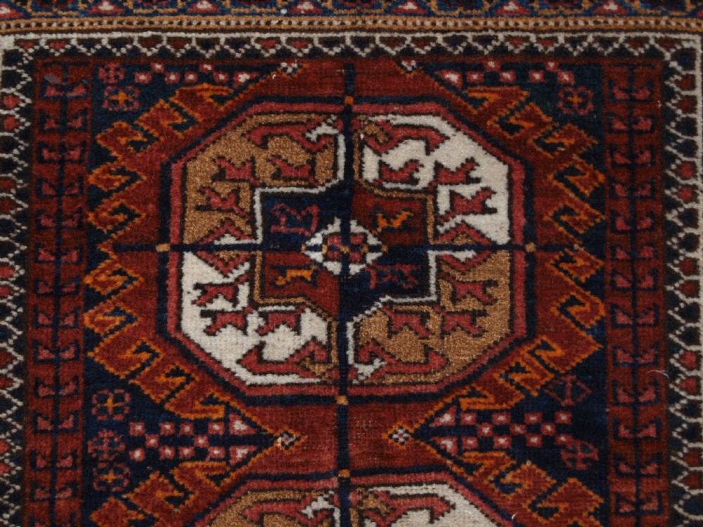 ANTIQUE BALUCH RUG BY THE MAHDAD KHANI TRIBE, LARGE TEKKE GULS, CIRCA 1900. View VI