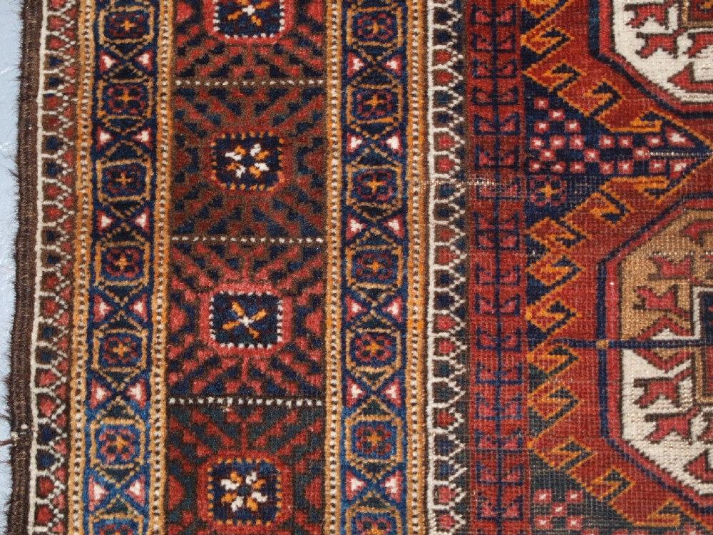 ANTIQUE BALUCH RUG BY THE MAHDAD KHANI TRIBE, LARGE TEKKE GULS, CIRCA 1900. View VII