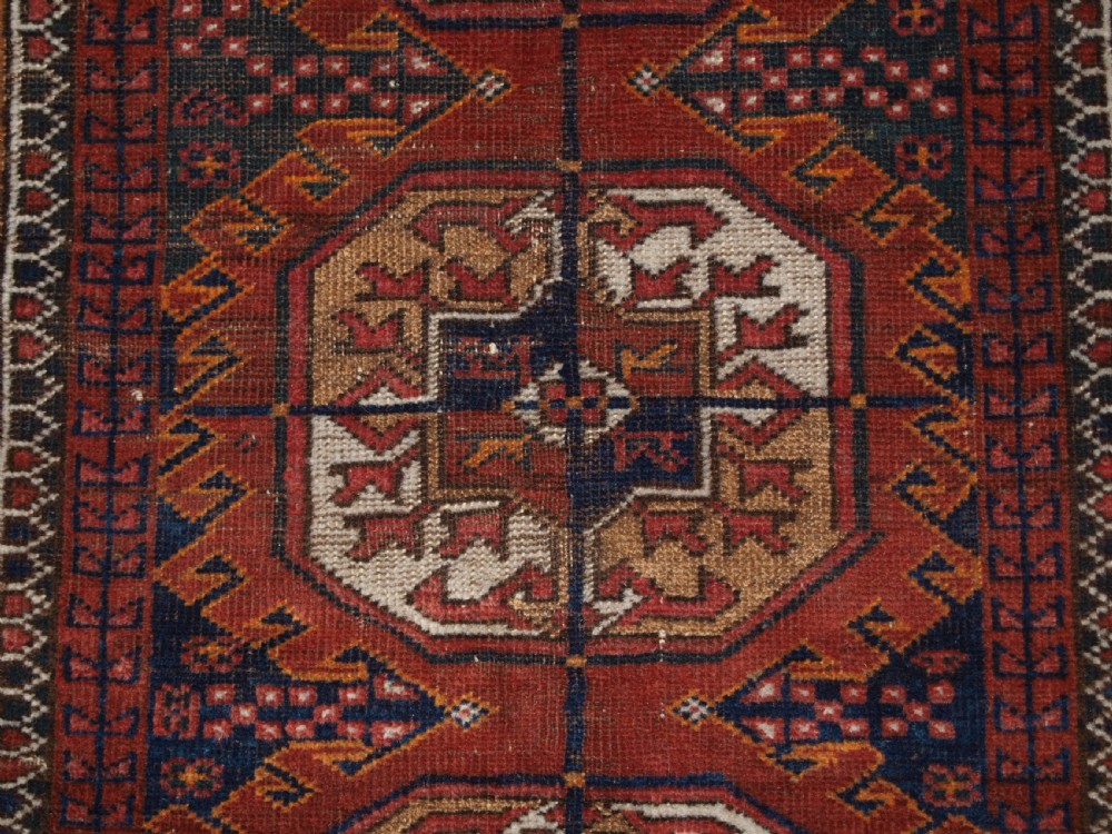 ANTIQUE BALUCH RUG BY THE MAHDAD KHANI TRIBE, LARGE TEKKE GULS, CIRCA 1900. View VIII