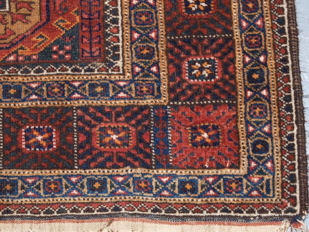 ANTIQUE BALUCH RUG BY THE MAHDAD KHANI TRIBE, LARGE TEKKE GULS, CIRCA 1900. View IX