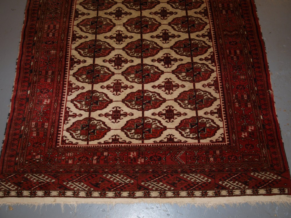 OLD AFGHAN TURKMEN RUG WITH TEKKE DESIGN ON A SCARCE IVORY GROUND. CIRCA 1920. View IV