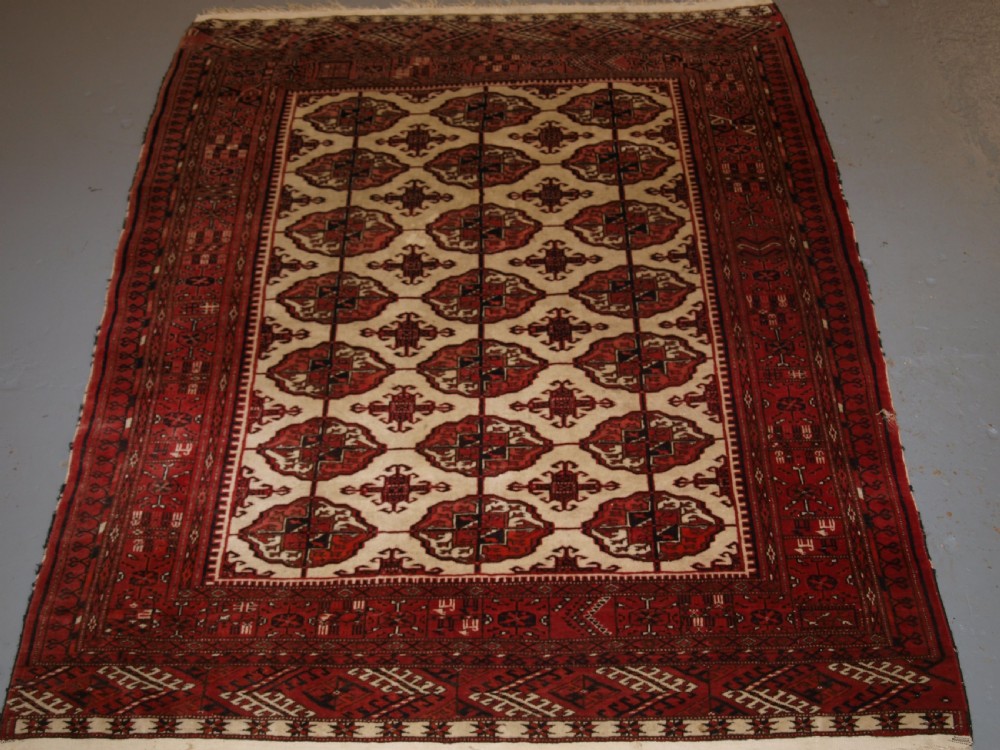 OLD AFGHAN TURKMEN RUG WITH TEKKE DESIGN ON A SCARCE IVORY GROUND. CIRCA 1920. View XII