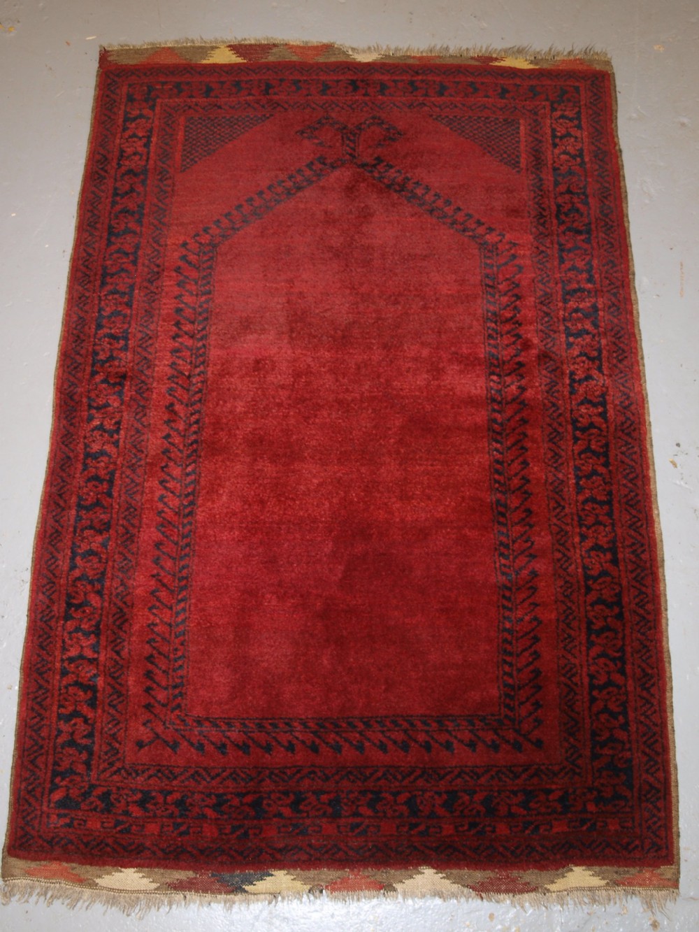 OLD AFGHAN VILLAGE PRAYER RUG WITH RAMS HORN DESIGN, OUTSTANDING EXAMPLE, CIRCA 1920.