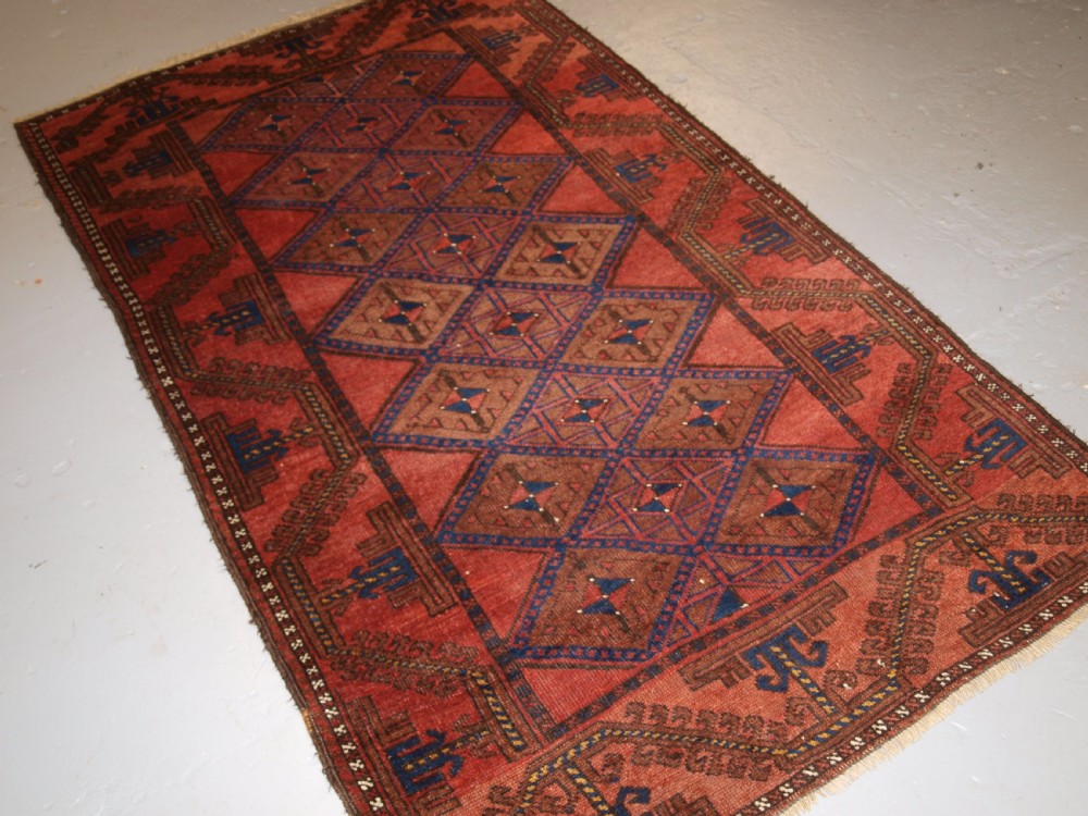 ANTIQUE AFGHAN RUG OF BALUCH LATTICE DESIGN, WARM COLOURS, CIRCA 1900/20. View II