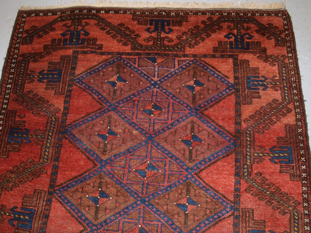 ANTIQUE AFGHAN RUG OF BALUCH LATTICE DESIGN, WARM COLOURS, CIRCA 1900/20. View III