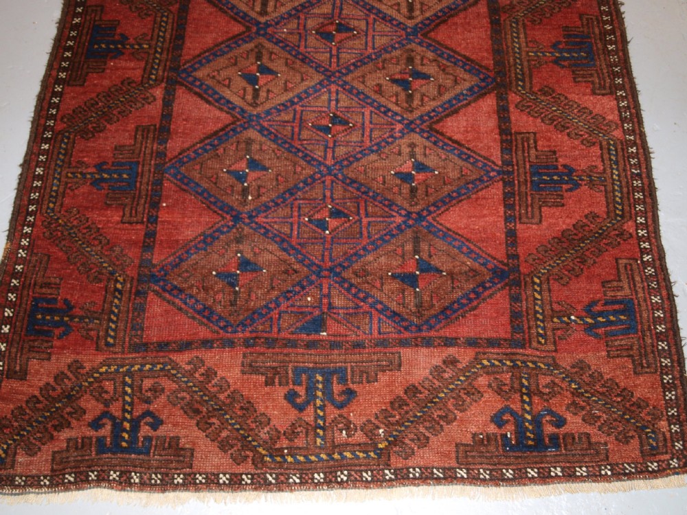 ANTIQUE AFGHAN RUG OF BALUCH LATTICE DESIGN, WARM COLOURS, CIRCA 1900/20. View V