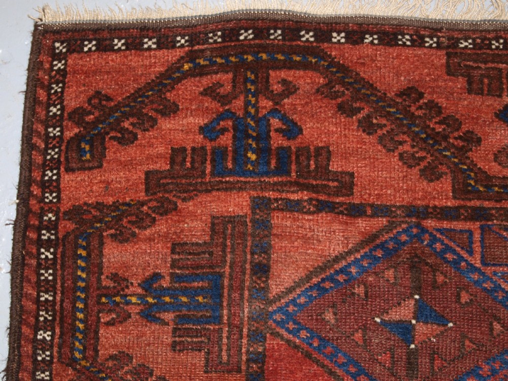 ANTIQUE AFGHAN RUG OF BALUCH LATTICE DESIGN, WARM COLOURS, CIRCA 1900/20. View VI